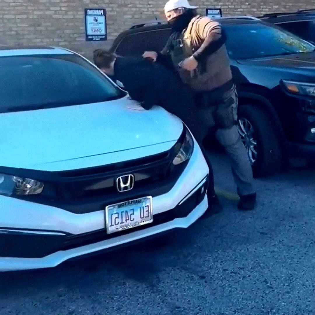 Illustrative photograph: St. Paul Erupts: Masked Federal Agent Pins Protester on Honda Hood as Frog-Suited Figure Grapples Cops in Explosive Recycled Video • The Complete Story
