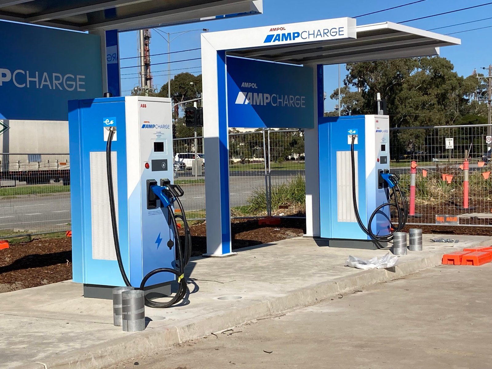 A high-amperage combined charging system connector engaged with a vehicle receptacle during an automated session audit.
