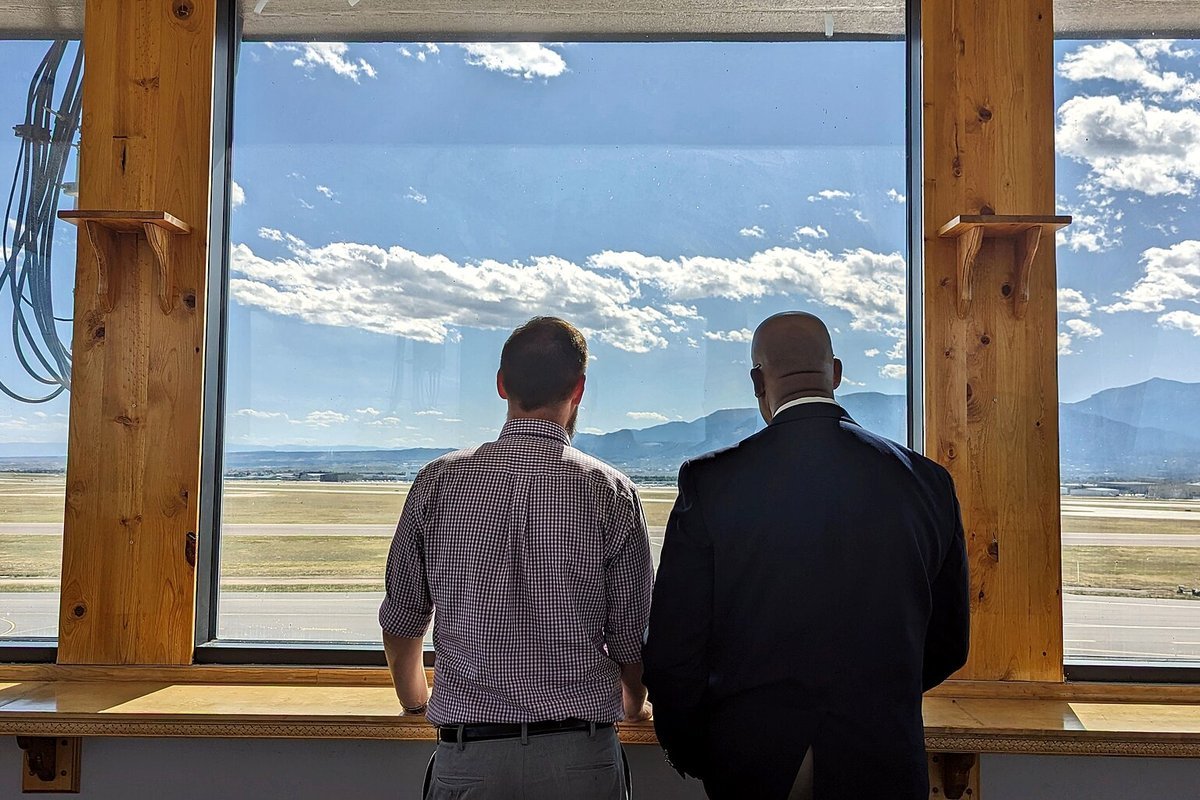 Airport air traffic control tower overseeing surface movements and runway operations