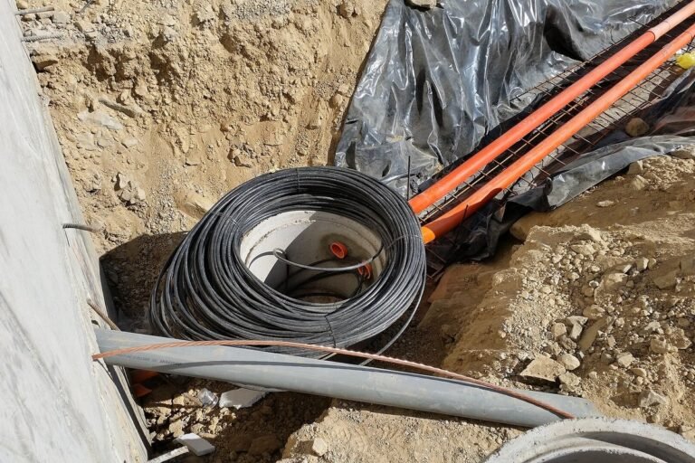 Telecommunications technician installing high-speed residential fiber-optic internet cabling