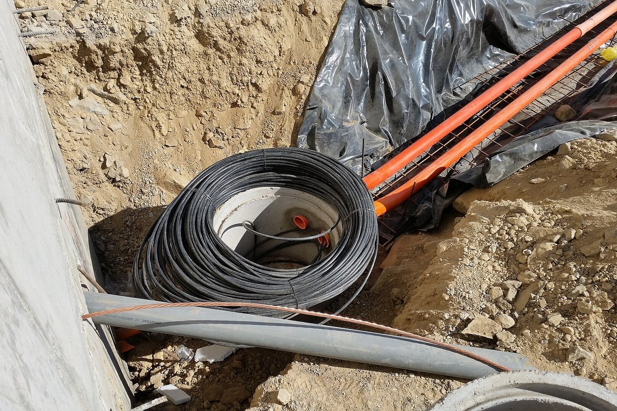 Telecommunications technician installing high-speed residential fiber-optic internet cabling
