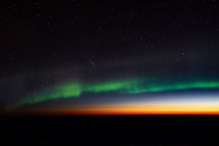 Vibrant green aurora borealis curtain illuminating the northern horizon during a geomagnetic storm