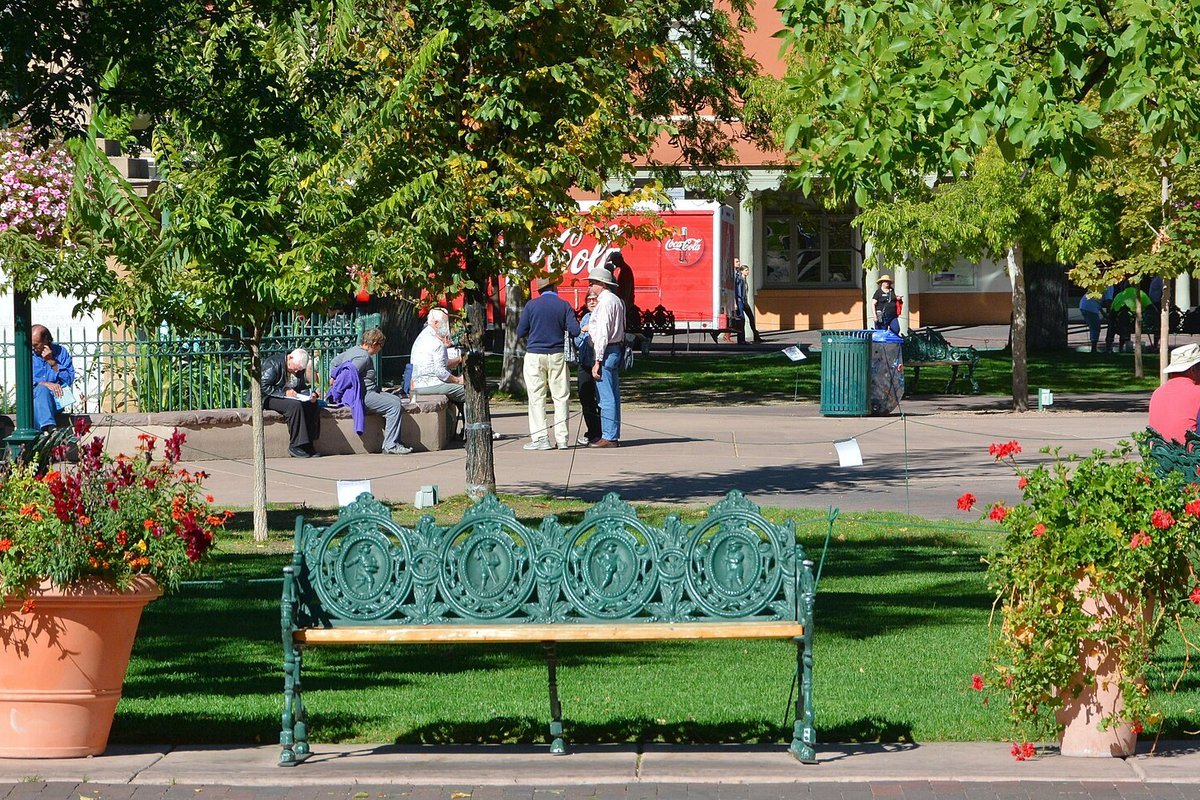 The historic Santa Fe Plaza surrounded by authentic Pueblo Revival adobe buildings in downtown Santa Fe